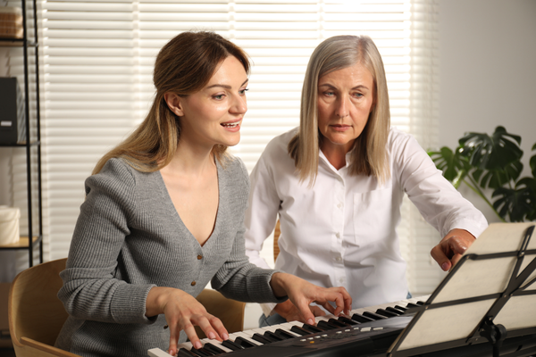 Older Woman Teaching Piano Older Woman Teaching Piano